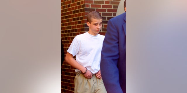 Convicted Westside Middle School shooter Andrew Golden, 13, being escorted from a back door of the Craighead County Courthouse in Jonesboro, Ark., in April 2000. (Rodney Freeman/The Jonesboro Sun via AP, File)