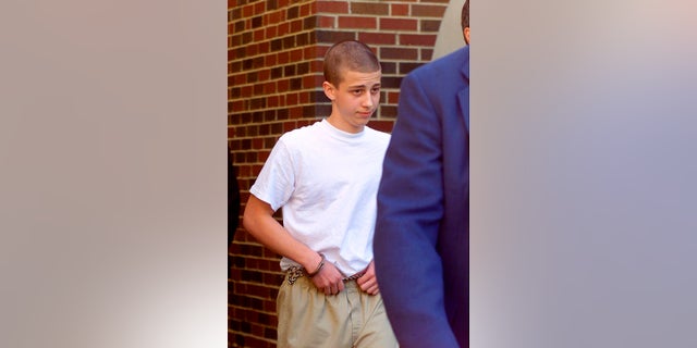 Convicted Westside Middle School shooter Andrew Golden, 13, being escorted from a back door of the Craighead County Courthouse in Jonesboro, Ark., in April 2000. [Rodney Freeman/The Jonesboro Sun via AP, File)