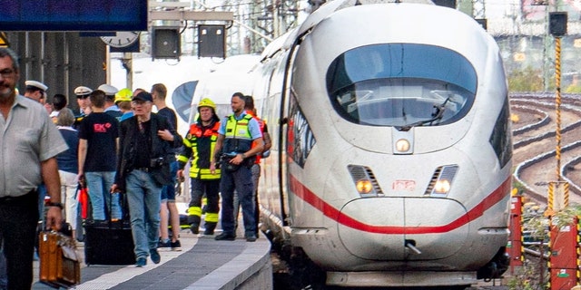Firefighters and Police officers stay next to an ICE highspeed train at the main station in Frankfurt, Germany.