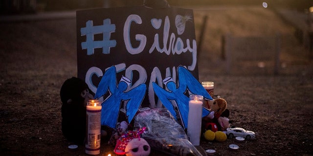 Candles at a makeshift memorial for Gilroy Garlic Festival shooting victims outside the festival grounds on Monday. (AP Photo/Noah Berger)