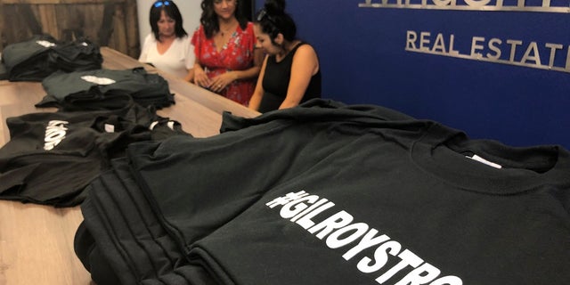 Employees and volunteers at Windermere Real Estate working to sell "#Gilroy Strong" T-shirts, with proceeds benefiting shooting victims, in Gilroy, Calif. (AP Photo/Haven Daley)