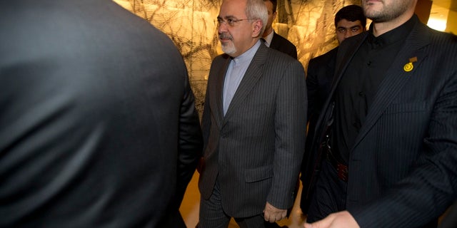 In this Nov. 9, 2013, photo, Iranian Foreign Minister Mohammad Javad Zarif, center, leaves following a meeting with E.U. foreign ministers in Geneva. (Jason Reed/Poo Photo via APl, File)