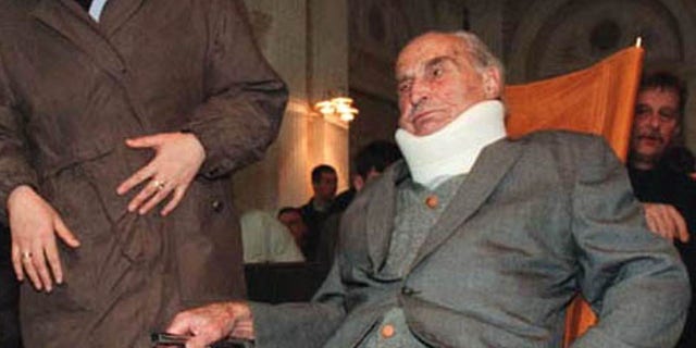 Former head of the Vilnius region security police under Nazi occupation, Aleksandras Lileikis, listens during a trial November 5.
