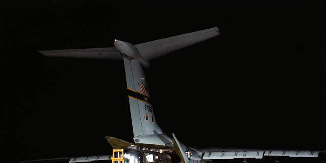 The MQF with the three Apollo 11 astronauts is unloaded from a U.S. Air Force C-141 jet transport at Ellington Air Force Base. (NASA)