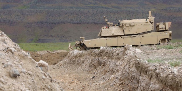 A remote-controlled concept assault breacher vehicle prepares to breach an obstacle during field testing at the Joint Warfighting Assessment 19, April 28, 2019.
