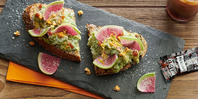Avocado Toast-ada, served on local multigrain toast with avocado, breakfast radish, chipotle seasoned sorghum and diablo puffs.