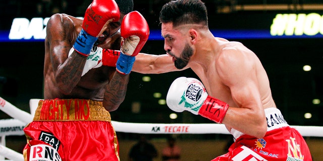 Jose Ramirez, right, lands a punch on Maurice Hooker in the second round of a boxing match, Saturday, July 27, 2019, in Arlington, Texas. Ramirez won in the sixth round with a TKO. (AP Photo/Brandon Wade)