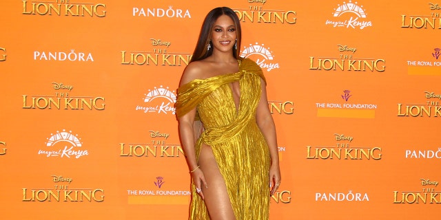 Beyonce poses for photographers upon arrival at the 'Lion King' European premiere in central London, Sunday, July 14.