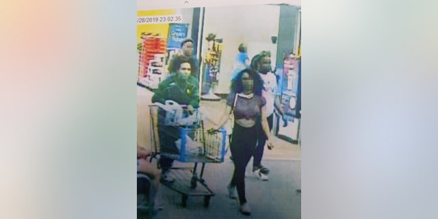 Still from store video showing the suspected "Blue Bell Licker" and her boyfriend. The girl, a juvenile whose name has not been released, has been identified by Lufkin, Texas police as the person who licked a tub of ice cream in a Walmart store then put it back in the freezer. 