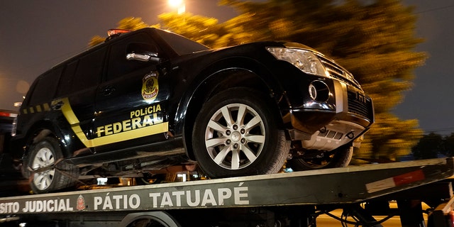 A fake police truck that was used in robbery is transported on a flat-bed truck in Sao Paulo, Brazil, Thursday, July 25, 2019. (AP Photo/Victor R. Caivano)
