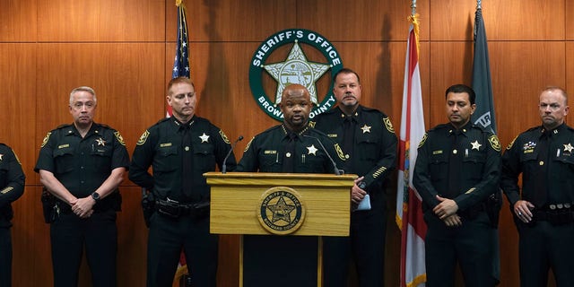 Broward Sheriff Gregory Tony, center, announces that two additional deputies have been fired as a result of the agency's internal affairs investigation into the mass shooting at Marjory Stoneman Douglas High School in Parkland, at the Broward Sheriff's Office headquarters in Fort Lauderdale, Fla., Wednesday, June 26, 2019.