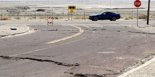 An earthquake-damaged street is seen Saturday, July 6, 2019, in Trona, Calif.