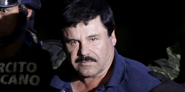 Recaptured drug lord Joaquin "El Chapo" Guzman is escorted by soldiers at the hangar belonging to the office of the Attorney General in Mexico City, Mexico January 8, 2016. REUTERS/Henry Romero/File Photo