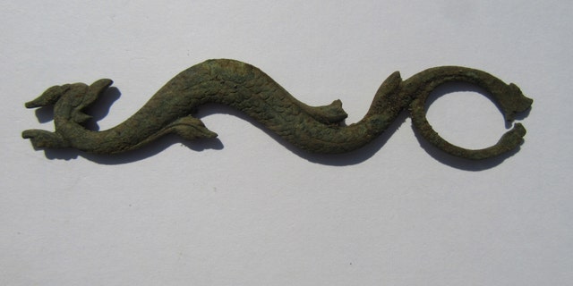The serpent-shaped sideplate is from a British trade gun that dates back to the 1760s or 1770s.