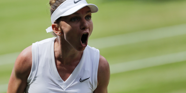 Romania's Simona Halep celebrates winning a point against Ukraine's Elina Svitolina in a Women's semifinal singles match on day ten of the Wimbledon Tennis Championships in London, Thursday, July 11, 2019. (AP Photo/Ben Curtis)