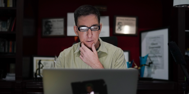 In this July 10, 2019 photo, U.S. journalist Glenn Greenwald checks his news website at his home in Rio de Janeiro, Brazil. (AP Photo/Leo Correa)
