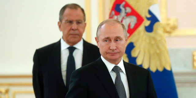 Russian President Vladimir Putin, center, and Russian Foreign Minister Sergei Lavrov attend a ceremony to receive credentials from newly appointed foreign ambassadors to Russia in Kremlin, Moscow, Russia, Wednesday, July 3, 2019. (Maxim Shipenkov/Pool Photo via AP)