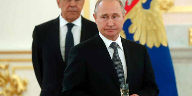 Russian President Vladimir Putin, center, and Russian Foreign Minister Sergei Lavrov attend a ceremony to receive credentials from newly appointed foreign ambassadors to Russia in Kremlin, Moscow, Russia, Wednesday, July 3, 2019. (Maxim Shipenkov/Pool Photo via AP)