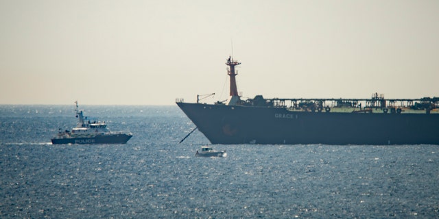 A view of the Grace 1 supertanker near a Royal Marine patrol vessel in the British territory of Gibraltar, Thursday, July 4, 2019. Spain's acting foreign minister says a tanker stopped off Gibraltar and suspected of taking oil to Syria was intercepted by British authorities after a request from the United States. (AP Photo/Marcos Moreno)