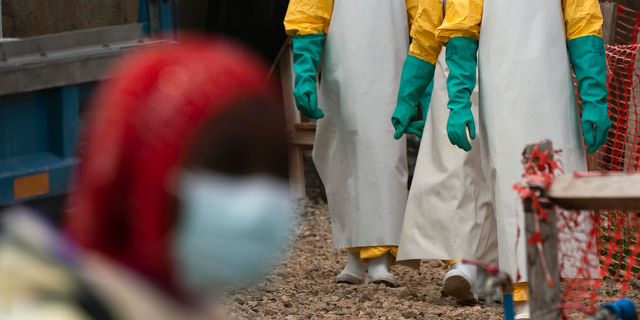 In this Tuesday, July 16, 2019 photo, health workers dressed in protective gear begin their shift at an Ebola treatment center in Beni, Congo DRC. The World Health Organization has declared the Ebola outbreak an international emergency after spreading to eastern Congo's biggest city, Goma, this week. More than 1,600 people in eastern Congo have died as the virus has spread in areas too dangerous for health teams to access. (AP Photo/Jerome Delay)