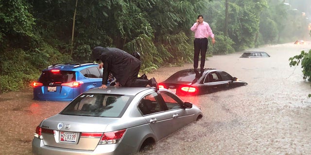 Motorists are stranded on a flooded section of Canal Road in Washington during a heavy rainstorm, Monday, July 8, 2019.