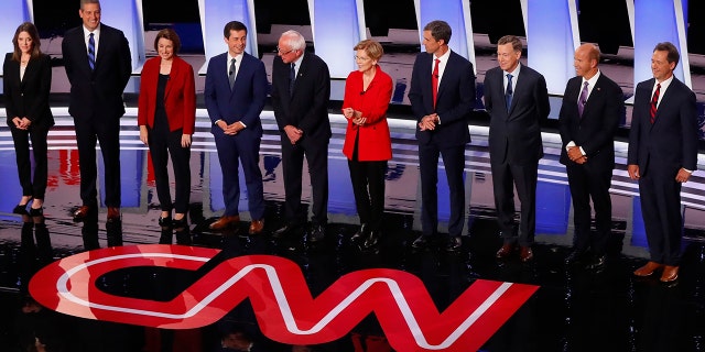 From left, Marianne Williamson, Rep. Tim Ryan, D-Ohio, Sen. Amy Klobuchar, D-Minn., South Bend Mayor Pete Buttigieg, Sen. Bernie Sanders, I-Vt., Sen. Elizabeth Warren, D-Mass., former Texas Rep. Beto O'Rourke, former Colorado Gov. John Hickenlooper, former Maryland Rep. John Delaney and Montana Gov. Steve Bullock take the stage for the first of two Democratic presidential primary debates hosted by CNN Tuesday, July 30, 2019, in the Fox Theatre in Detroit. (AP Photo/Paul Sancya)