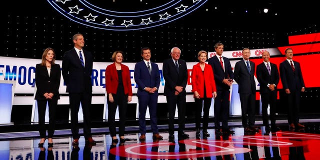 From left, Marianne Williamson, Rep. Tim Ryan, D-Ohio, Sen. Amy Klobuchar, D-Minn., South Bend Mayor Pete Buttigieg, Sen. Bernie Sanders, I-Vt., Sen. Elizabeth Warren, D-Mass., former Texas Rep. Beto O'Rourke, former Colorado Gov. John Hickenlooper, former Maryland Rep. John Delaney and Montana Gov. Steve Bullock take the stage for the first of two Democratic presidential primary debates in the Fox Theatre in Detroit. (AP Photo/Carlos Osorio)