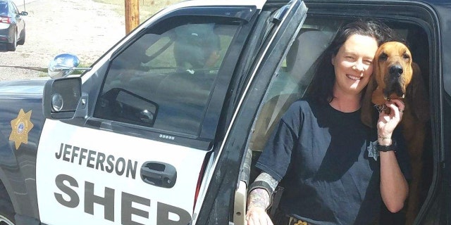 K. Fosler, deputy sheriff of Jefferson County, with a bloodhound 