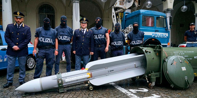 Police stand by a missile seized at an airport hangar near Pavia, northern Italy, following an investigation into Italians who took part in the Russian-backed insurgency in eastern Ukraine, in Turin, Italy.