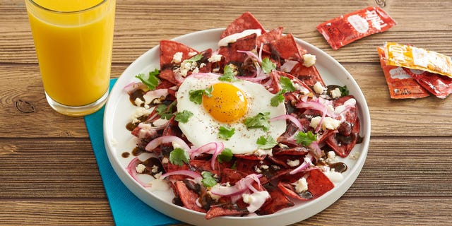 The Fire! Chip Chilaquiles with charred tomatillo salsa, Mexican crema, queso fresco, pico and a fried egg.
