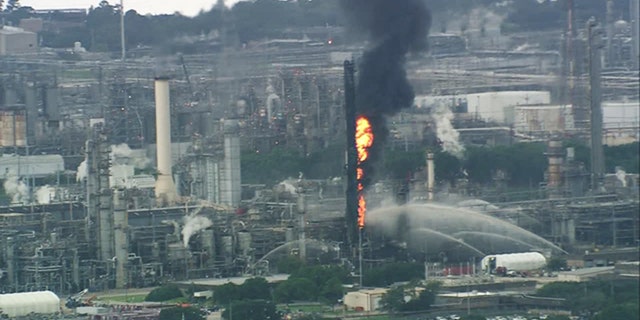 Emergency services respond to a fire at the Exxon Mobil Olefins plant in Baytown, Texas Wednesday