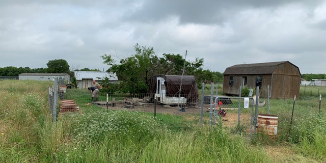 Officials said there were 18 "aggressive" dogs living on the property. When the animals were seized, two of the dogs had been killed by other dogs.