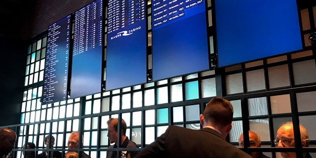 Employees at Rivers Casino and Resort prepare for the opening of its sports betting lounge in Schenectady, N.Y., Tuesday, July 16, 2019. New York joined the growing list of states allowing wagering on sports after the upstate casino cut the ribbon on a new betting lounge Tuesday and took its first bet — $20 on the Seattle Mariners. (AP Photo/David Klepper)