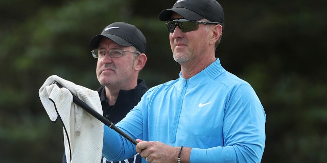 David Duval of the United States cleans one of his clubs as he waits to play on the 5th tee during the first round of the British Open Golf Championships at Royal Portrush in Northern Ireland, Thursday, July 18, 2019. (AP Photo/Jon Super)
