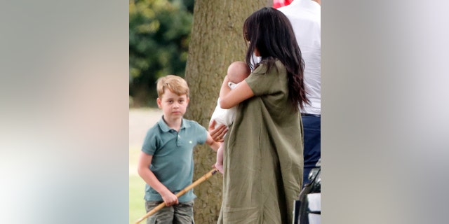 Prince George of Cambridge, Meghan, Duchess of Sussex and Archie Harrison Mountbatten-Windsor attend King Power's Royal Charity Polo Game