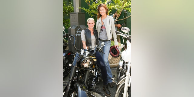 Katee Sackhoff (L) and Tricia Helfer (R) attend the 4th annual Kiehl's LifeRide for amfAR at The Grove on August 8, 2013, in Los Angeles, California. (Photo by Paul Archuleta/FilmMagic)