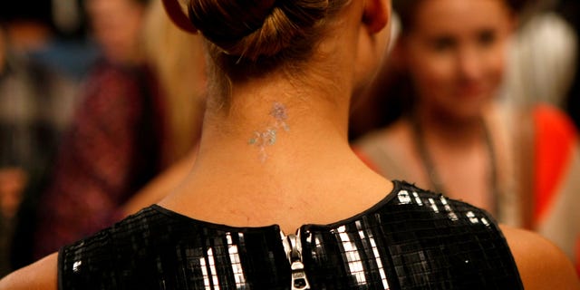 Jessica Alba's neck tattoo in 2010.(Photo by Michael Buckner/Getty Images for Mercedes-Benz)