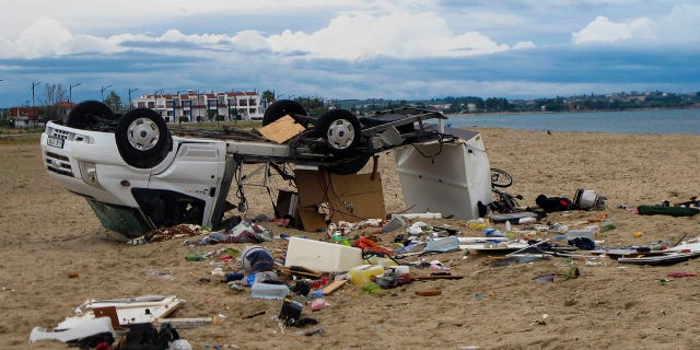 An overturned vehicle is seen on a beach at Sozopoli village in Halkidiki region, northern Greece, Thursday, July 11, 2019.