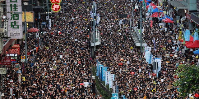 Protesters flood the streets as they take part in a rally Monday, July 1, 2019, in Hong Kong.