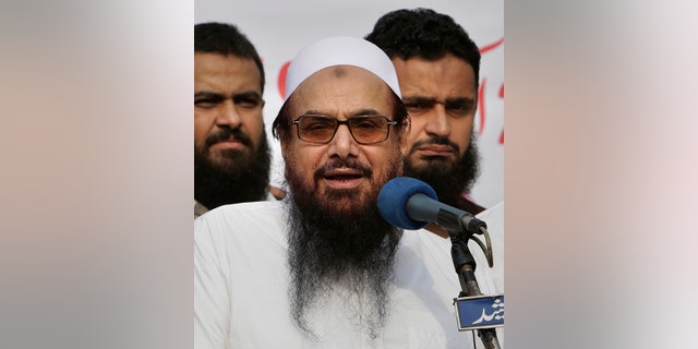 FILE - In this Friday, Oct. 26, 2018 file photo, Hafiz Saeed, founder of Pakistani religious group Jamaat-ud-Dawa addresses an anti-Indian rally in Lahore, Pakistan. (AP Photo/K.M. Chaudary, File)