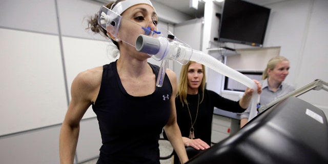 Research scientist Leila Walker, left, assisted by nutritional physiologist Holly McClung, center, as they demonstrated equipment designed to evaluate fitness levels in female soldiers, not shown, this past April at the U.S. Army Combat Capabilities Development Command Soldier Center in Natick, Mass. (AP Photo/Steven Senne)