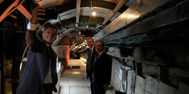 People take selfies inside an ancient tunnel during the opening of an ancient road at the City of David, a popular archaeological and tourist site in the Palestinian neighborhood of Silwan in east Jerusalem. The site is located on what many believe to be the ruins of the biblical King David's ancient capital and see as centerpieces of ancient Jewish civilization, but critics accuses the operators of pushing a nationalistic agenda at the expense of local Palestinian residents. (AP Photo/Tsafrir Abayov, Pool)