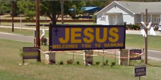 The city of Hawkins and a church congregation are fighting over a "Jesus Welcomes You to Hawkins" sign alongside U.S. 80 that was removed overnight.