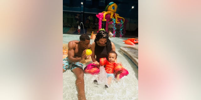 Singer and actress Jordin Sparks, center, plays in the shallow end at Kalahari Resorts with husband Dana Isaiah, left, and their son DJ.