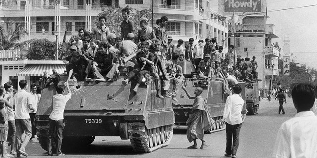 Khmer Rouge soldiers atop US-made armored vehicles in Phnom Penh, Cambodia, in April 1975. (SJOBERG/AFP/Getty Images, File)