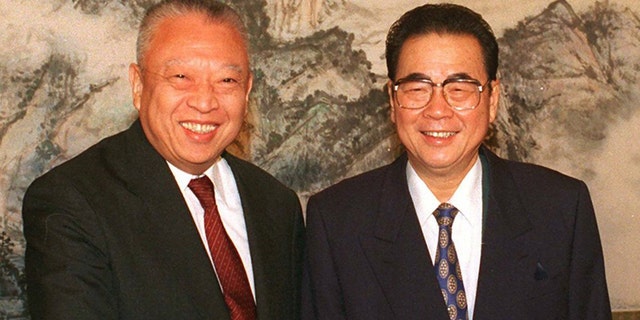 In this Dec. 10, 1997, file photo released by CHina's Xinhua News Agency, then Hong Kong leader Tung Chee-hwa and then Chinese Premier Li Peng shake hands at the start of their meeting in Beijing. Li Peng, a former hard-line Chinese premier best known for announcing martial law during the 1989 Tiananmen Square pro-democracy protests, has died. He was 90. (Xinhua via AP, File)