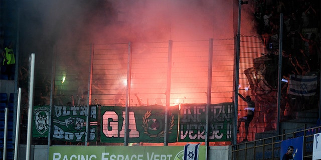 Maccabi Haifa fans light flares during Thursday's Europa League match against RC Strasbourg. (Photo by Anthony Dibon/Icon Sport via Getty Images)