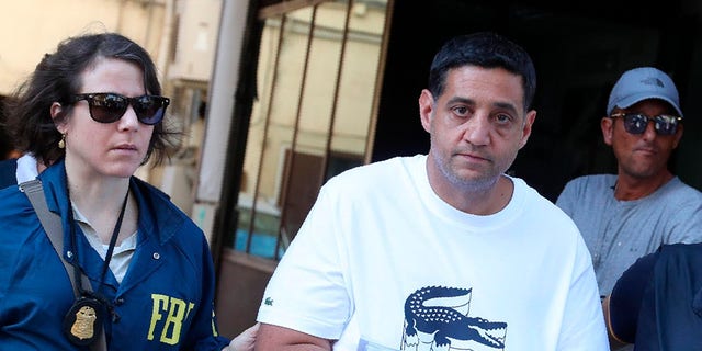 Suspect Thomas Gambino, right, is taken into custody during an anti-mafia operation lead by the Italian Police and the FBI in Palermo, Southern Italy, Wednesday, July 17, 2019. Italian police and the FBI arrested 19 suspected Mafiosi in a joint operation Wednesday following an investigation which revealed alleged ties between Sicily's Cosa Nostra Mafia and New York's Gambino crime family.