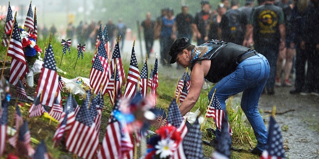 Bikers at the memorial site where seven bikers riding with the Jarheads Motorcycle Club were killed in a collision last month Saturday. (Paul Hayes/Caledonian-Record via AP)