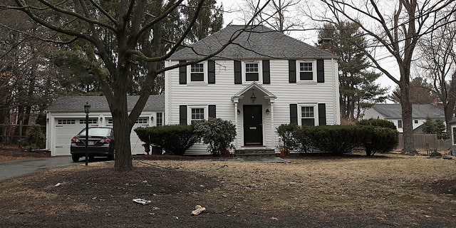 In this archival photo of March 20, 2019, a house that once belonged to Peter Brand is sitting on a tree in Needham, Massachusetts. Harvard University has fired its longtime fencing coach for the sale of his Boston suburban home to a wealthy son. His son was then admitted to school and joined the school. ;team. (Suzanne Kreiter / The Boston Globe via AP, File)